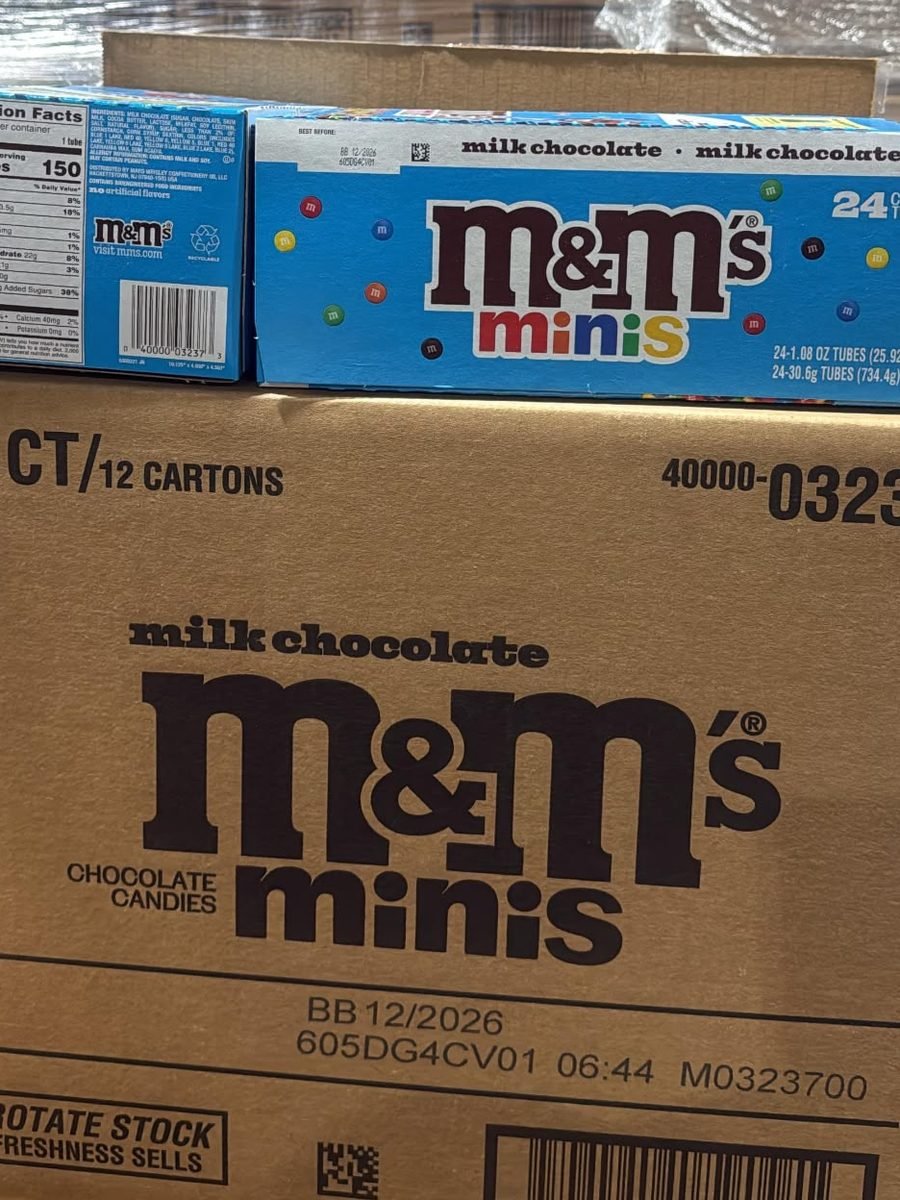 Candy buyers checking the best-by date 12/2026 on a case of M&M's Minis