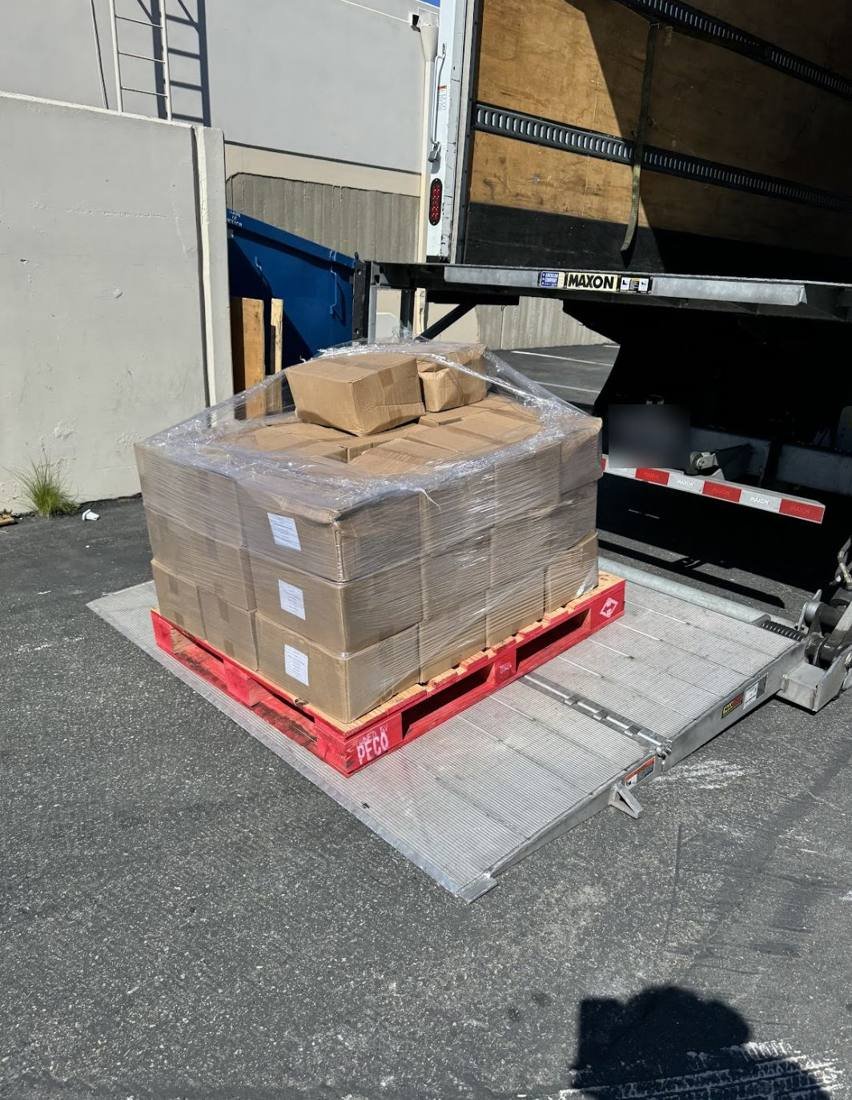 Candy liquidation pallet on a truck liftgate ready for loading