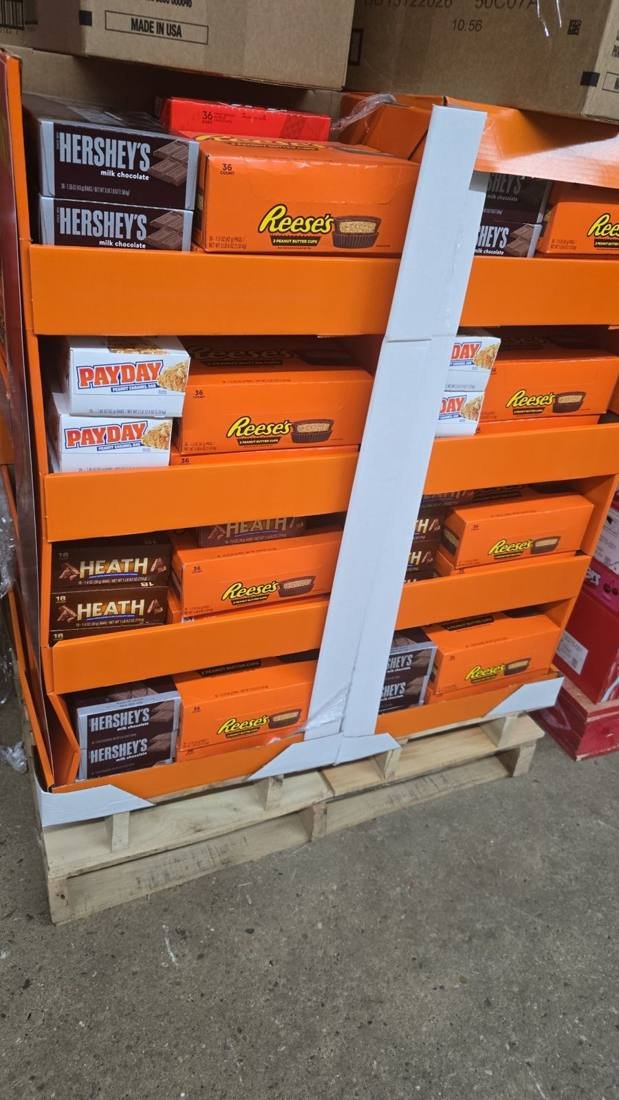 Mixed pallet of Hershey's, Reese's, Payday and Heath cartons, typical short-dated candy