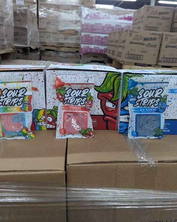Sour Strips display boxes stacked on a pallet of excess candy inventory