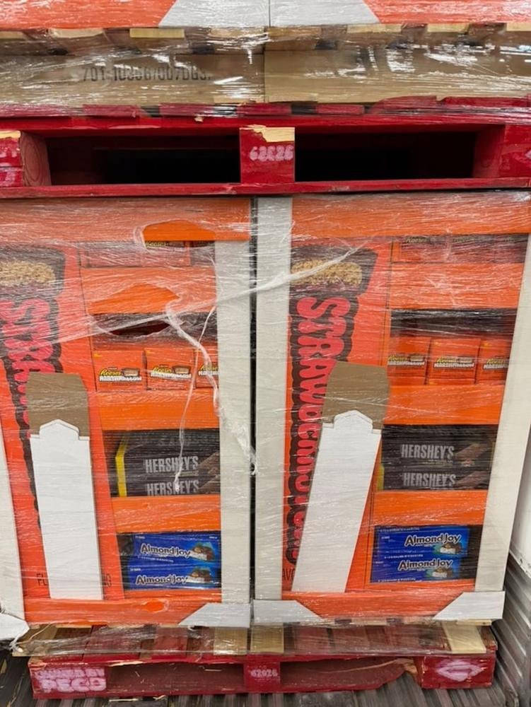 Wrapped orange display pallet of Reese's, Hershey's and Almond Joy candy for candy buyers
